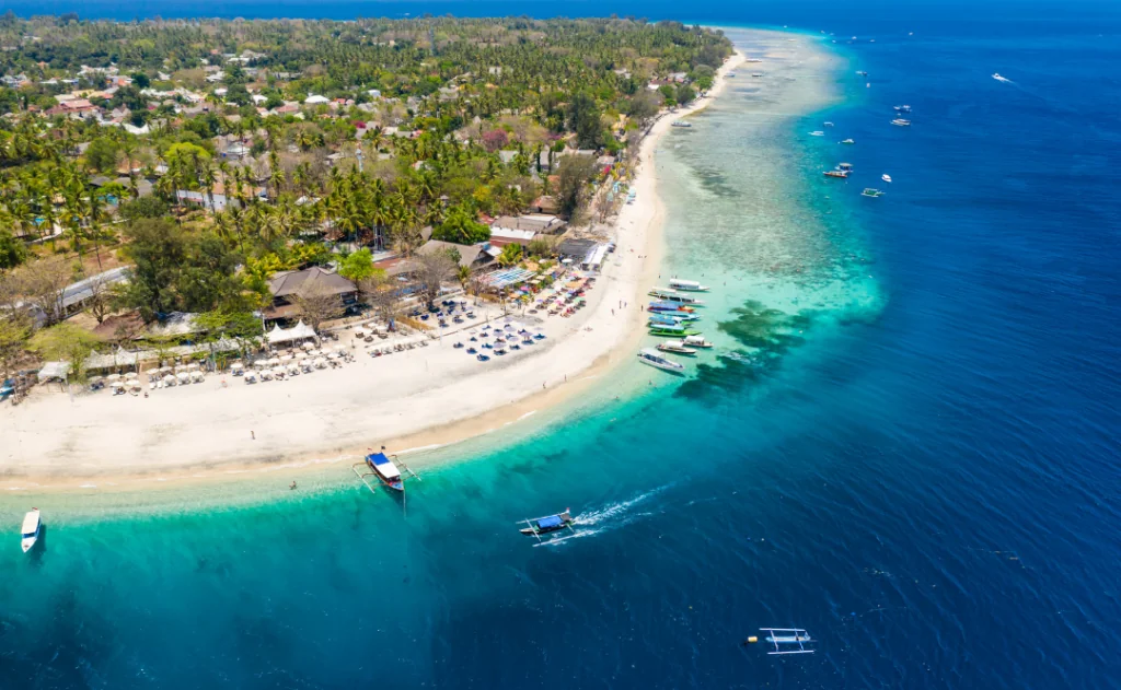 Aerial drone view of a beautiful tropical beach and coral reef in Gili Air, Indonesia