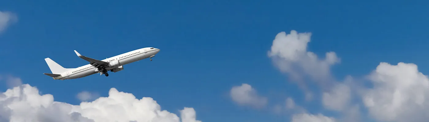 Airplane flying through the blue sky