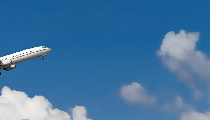 Airplane flying through the blue sky