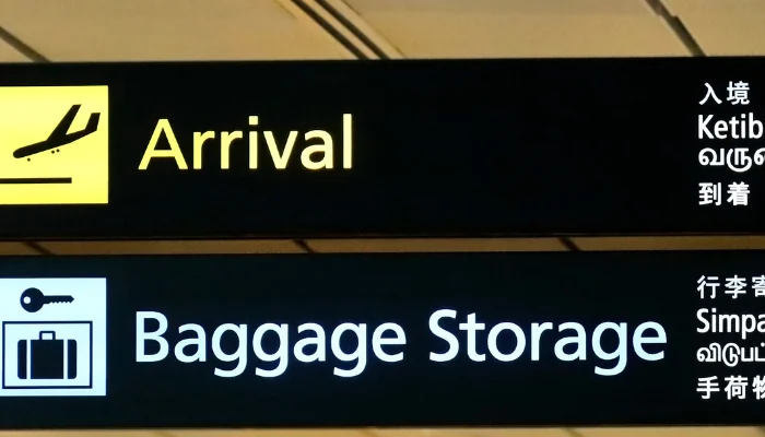 Arrival and luggage storage signs at Singapore Changi Airport.