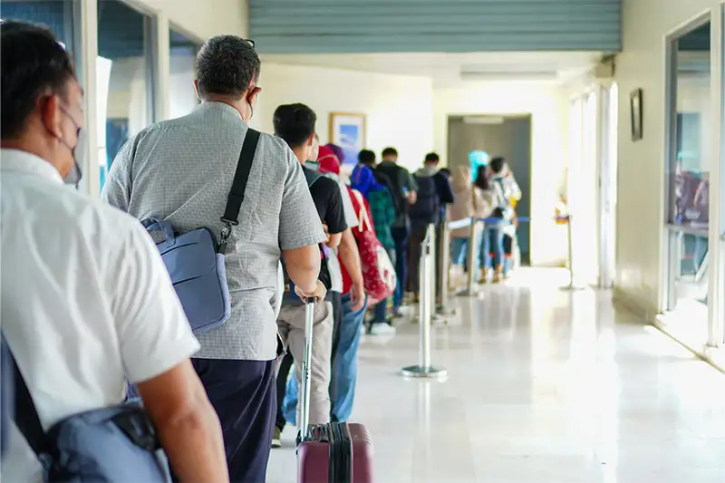 People waiting in line to board plane