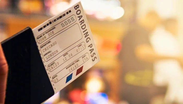 Boarding Pass Close Up In Crowded Airport Terminal