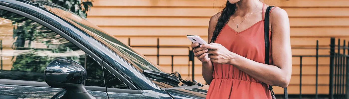 Woman calling a rideshare on her smartphone