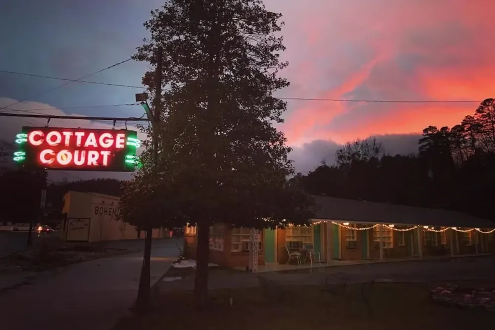 Exterior of Dame Fortune's Cottage Court under the sunset