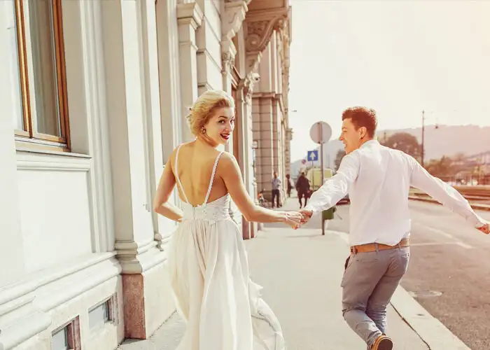 gorgeous wedding couple walking in the old city of Budapest