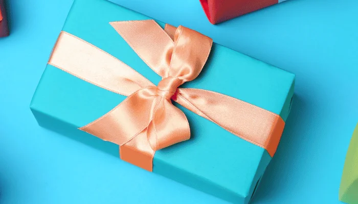 Flat lay composition with beautiful gift boxes on color background