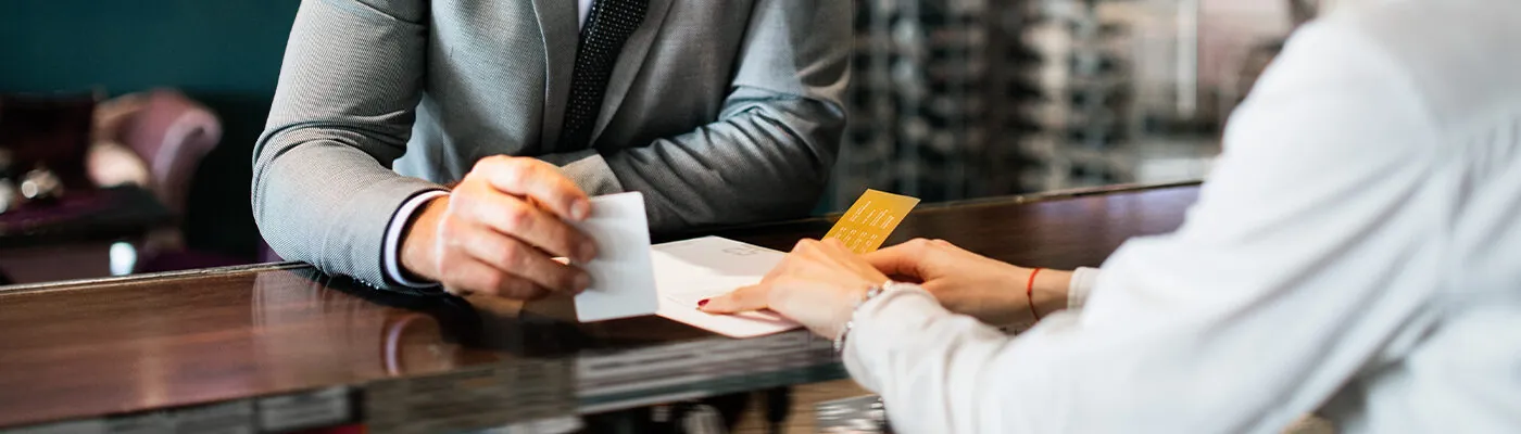 Person checking out at hotel front desk