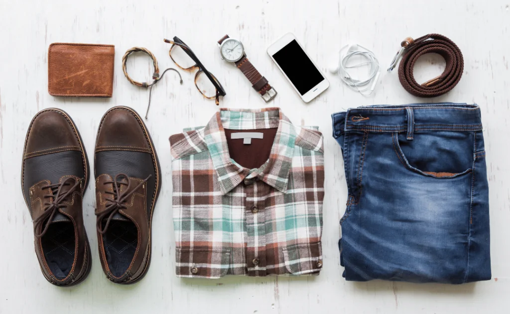 Men's casual outfits with man clothing and accessories on rustic wooden background, travel concept  