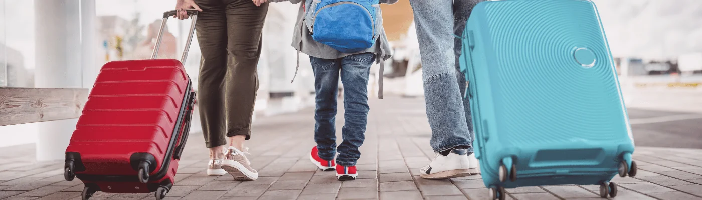 Family walking at airport with luggage