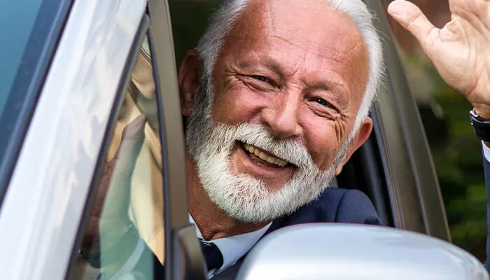 Elderly man driving car