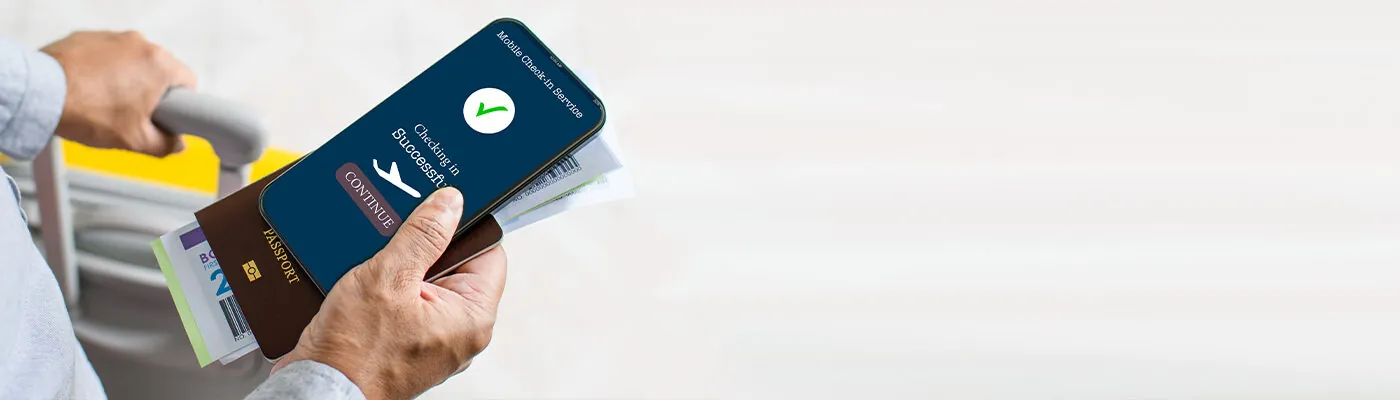 Tourists holding smartphones showing Concept Mobile check-in app check-in before their flight Business people use online devices to verify their identity. Close up, Copy space. Blurred background.