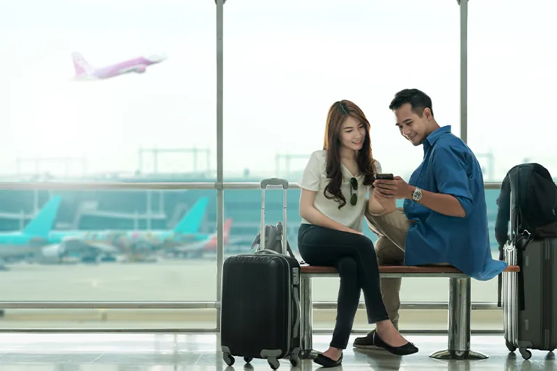 Couple on phone at airport