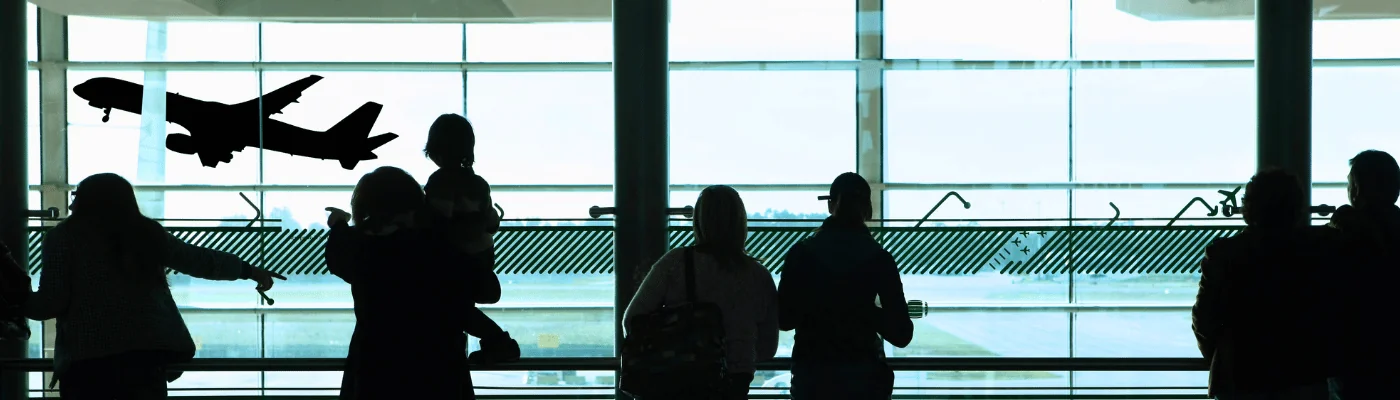 people looking out the window at the airport