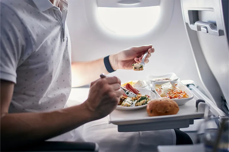 Person eating on airplane