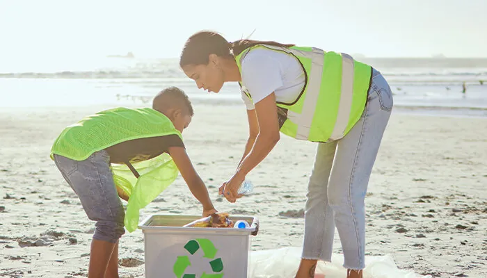 People recycling garbage on the beach