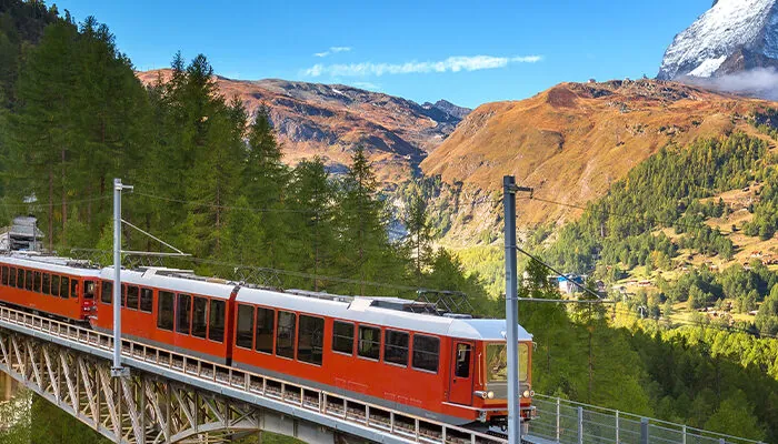 Zermatt, Switzerland. Gornergrat red tourist train on the bridge and Matterhorn peak panorama in Swiss Alps, benner