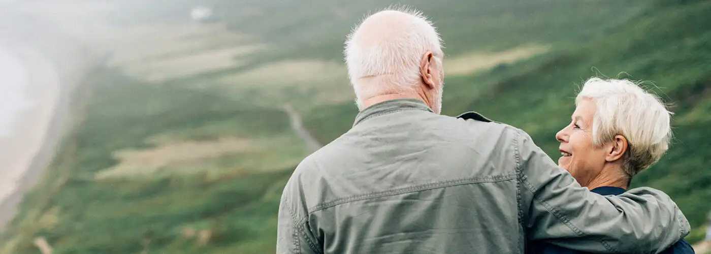 Happy senior couple enjoying a breathtaking view on vacation