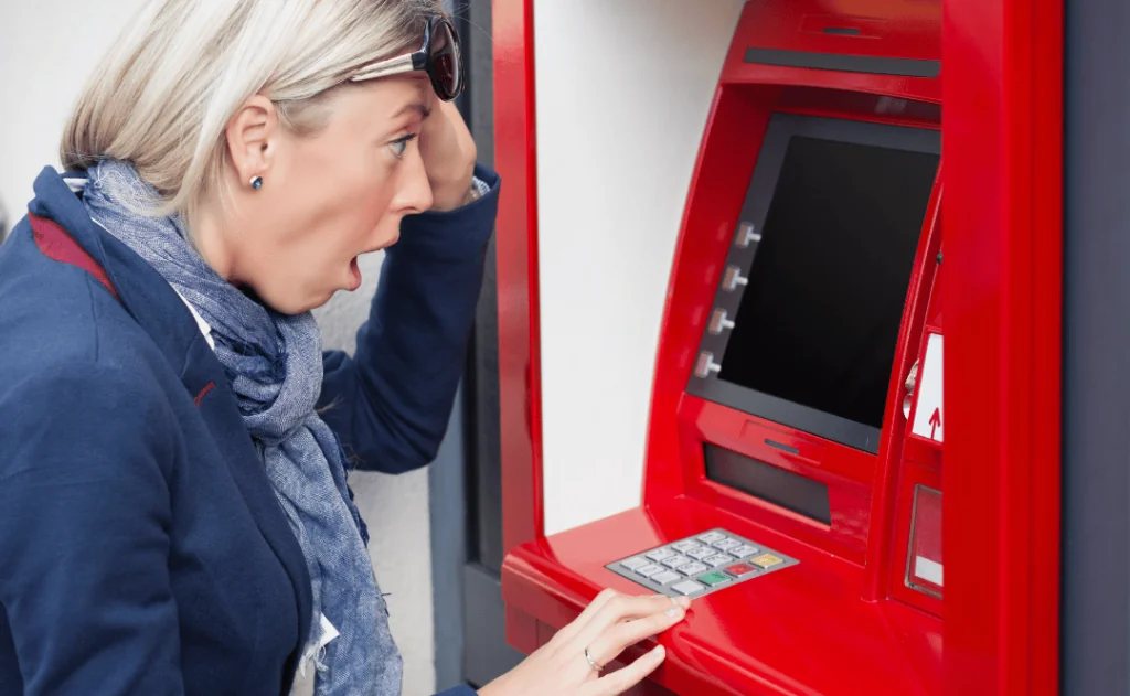 Shocked woman looking at her bank account balance