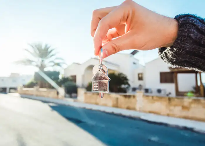 hand holding set of house keys.