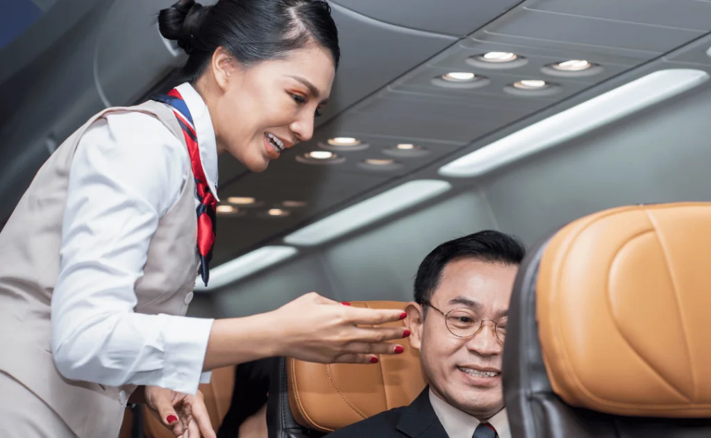 Stewardess checking in a man seated on in airplane