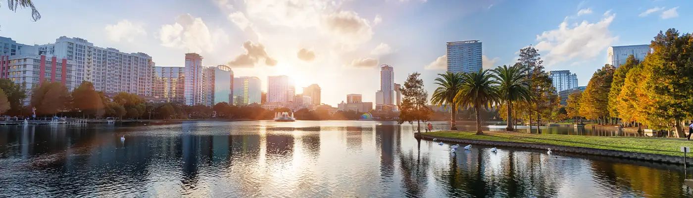 Sunset at Orlando in Lake Eola Park with water fountain and city skyline, Florida, USA