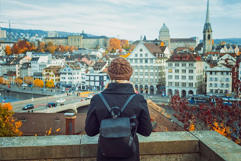 Tourist looking at a fall scene in Switzerland