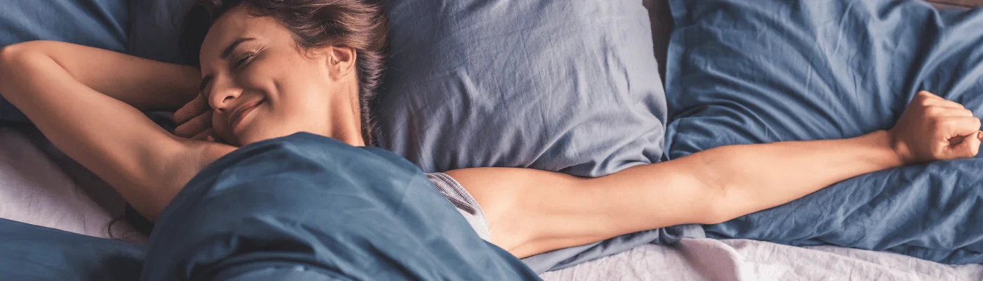 A young woman in bed having a good night's sleep