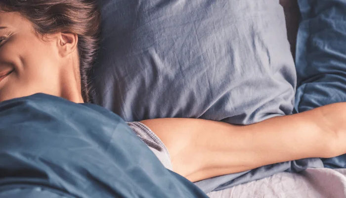 A young woman in bed having a good night's sleep